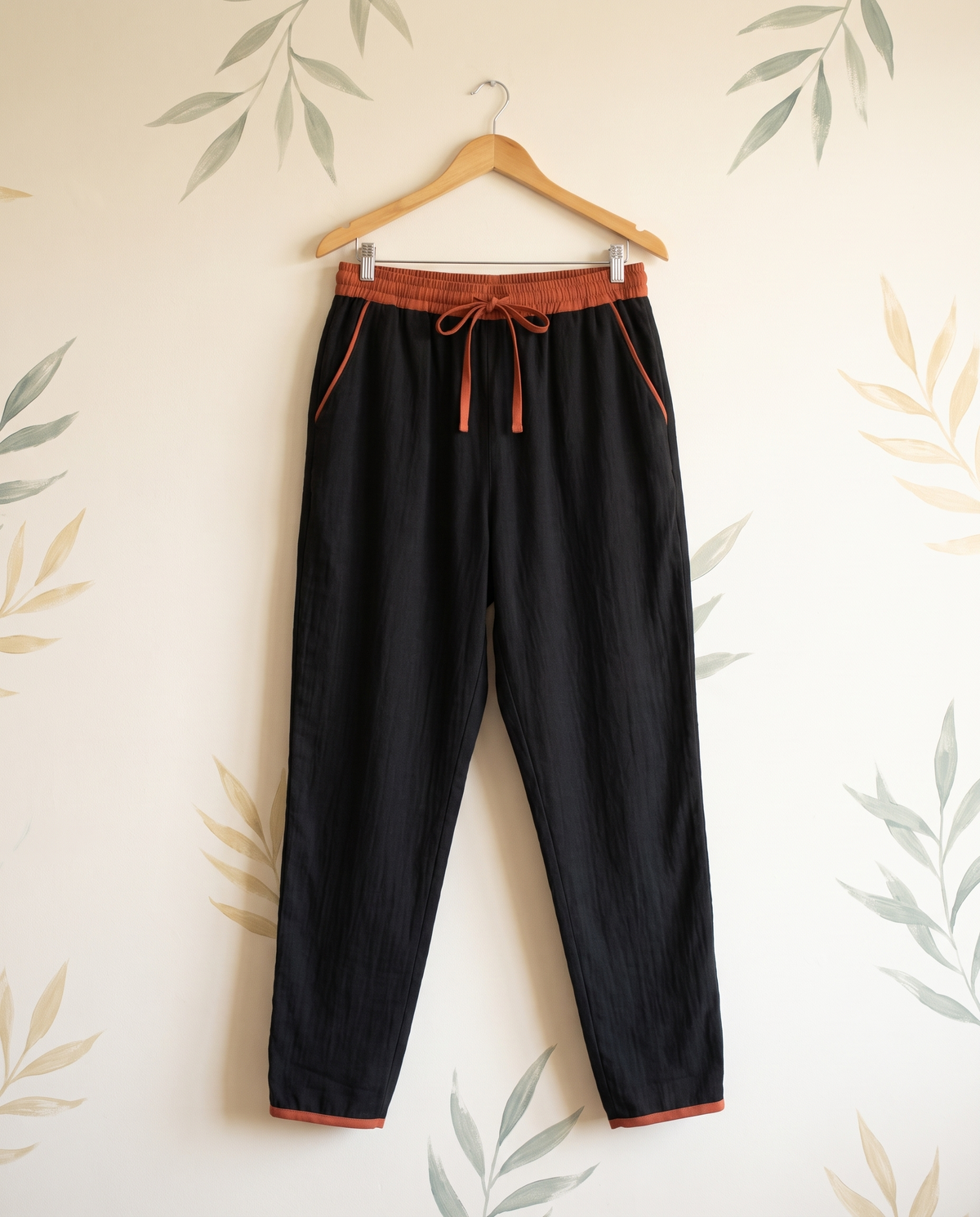 Cotton Drawstring Harem Pants with Pockets — in black, hanging view