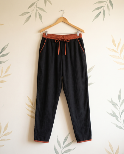 Cotton Drawstring Harem Pants with Pockets — in black, hanging view