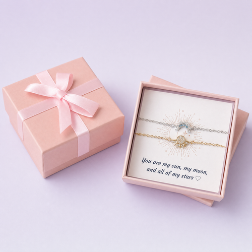 The Sun and Moon set in its gift box, beside the ribboned box it arrives in