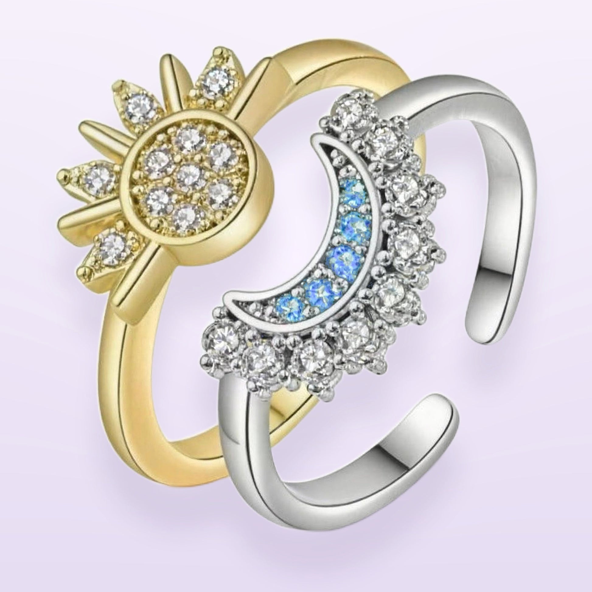 The ring set — gold sun ring and silver moon ring, both bands open