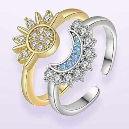 The ring set — gold sun ring and silver moon ring, both bands open